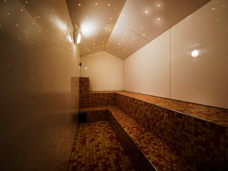 Sauna mit gefliesten Wänden im Wellnessbereich des natura Hotel Bodenmais.