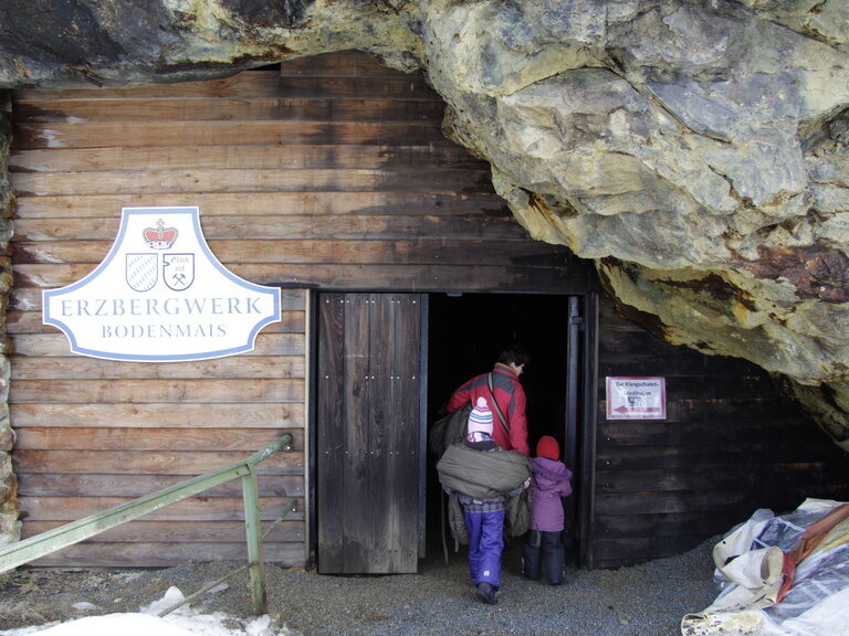Eine Frau mit Kind betritt das Erzbergwerk Bodenmais