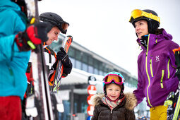 Eine Familie in Skiausrüstung in der Talstation des großen Arbers im Bayerischen Wald