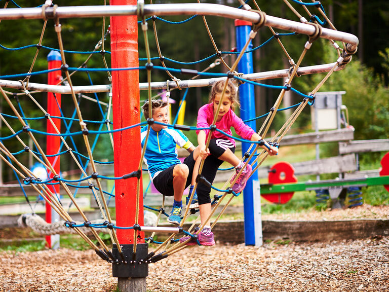 Kinder spielen auf dem Spielplatz eines Freiteitparks im Bayerischen Wald