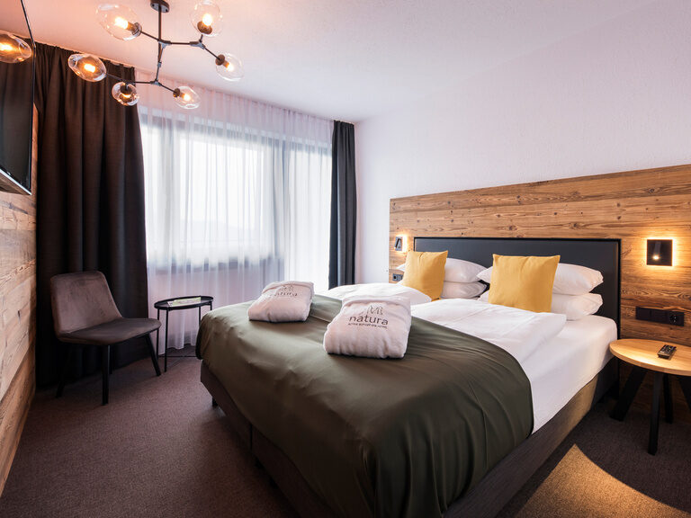 Modernes Schlafzimmer mit stilvollem Holzeinrichtung im Bodenmais Smart Hotelzimmer